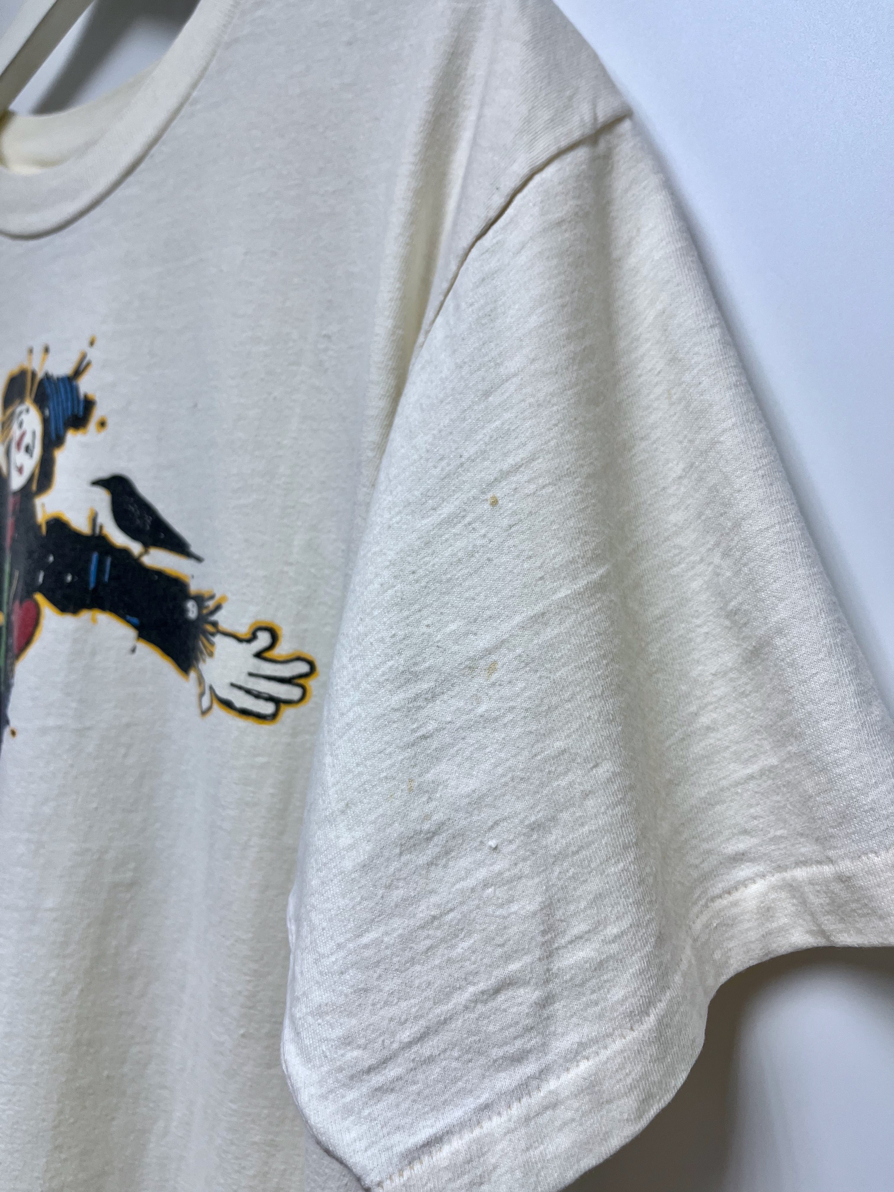 Gray t-shirt with a graphic design on a light blue background