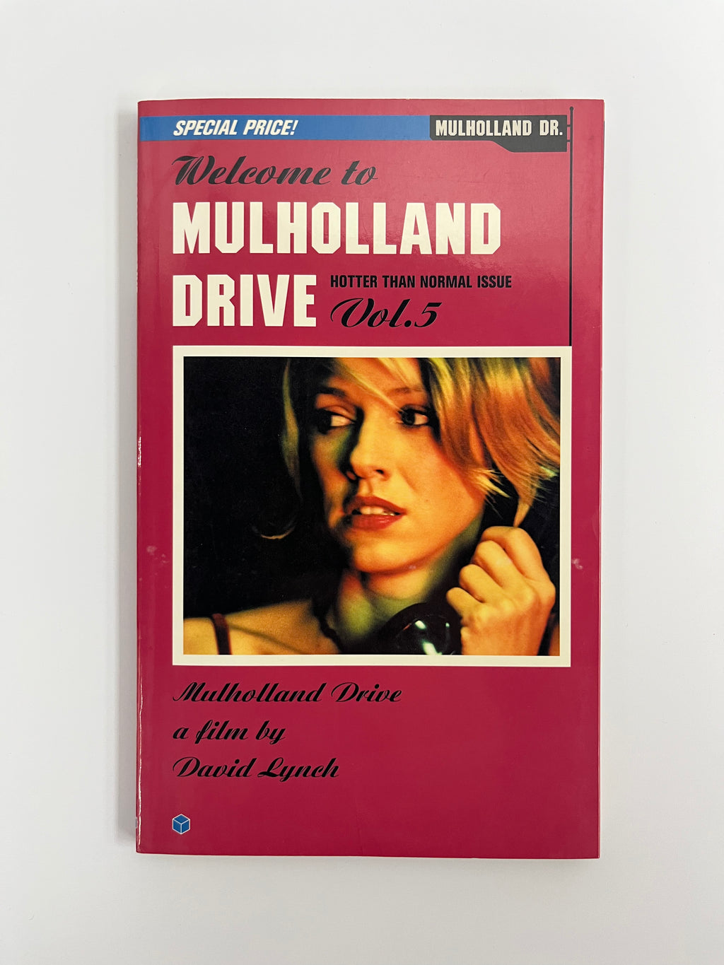 Book cover of 'Mulholland Drive' with a woman's face on a red background