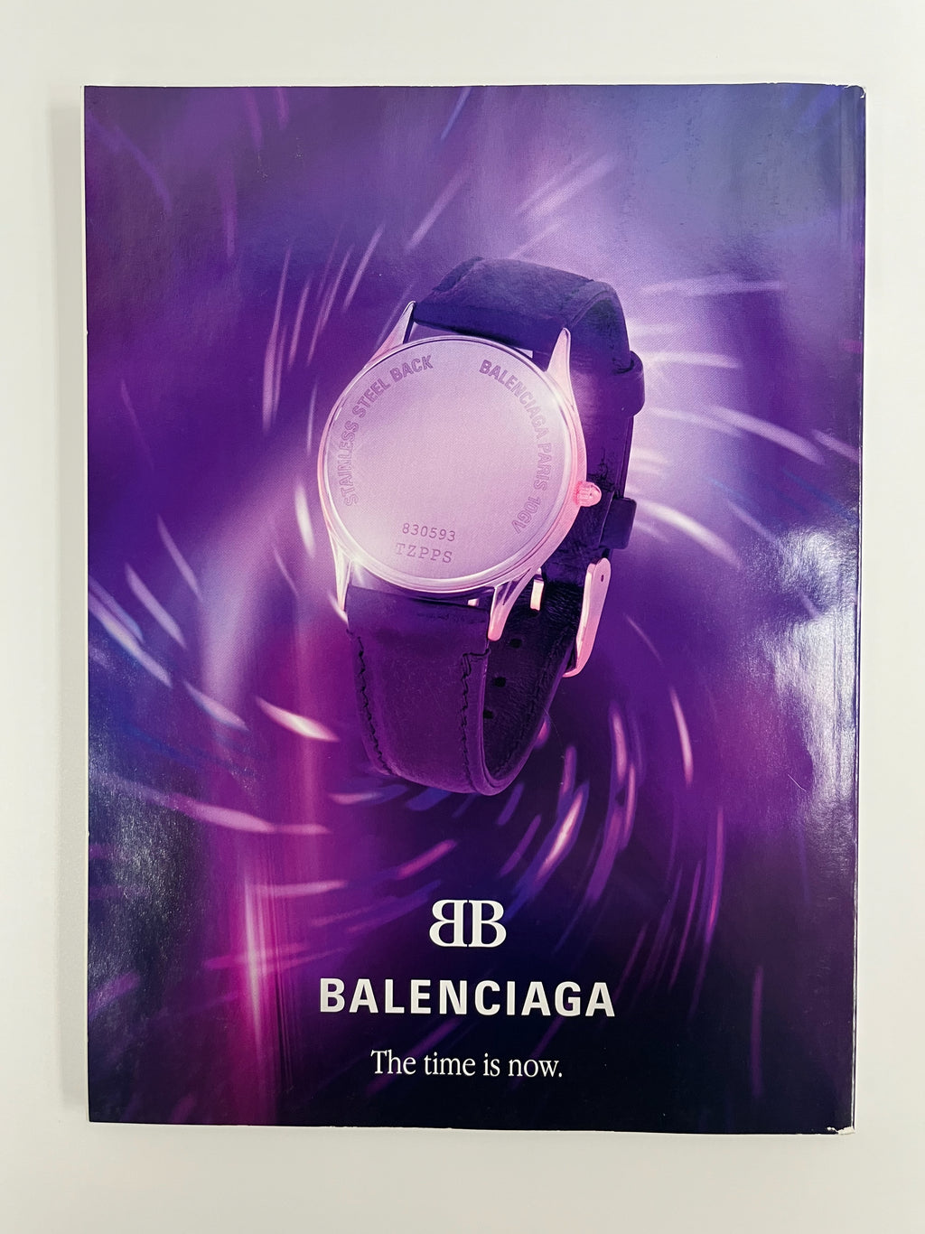 Balenciaga watch with a purple background and brand logo.