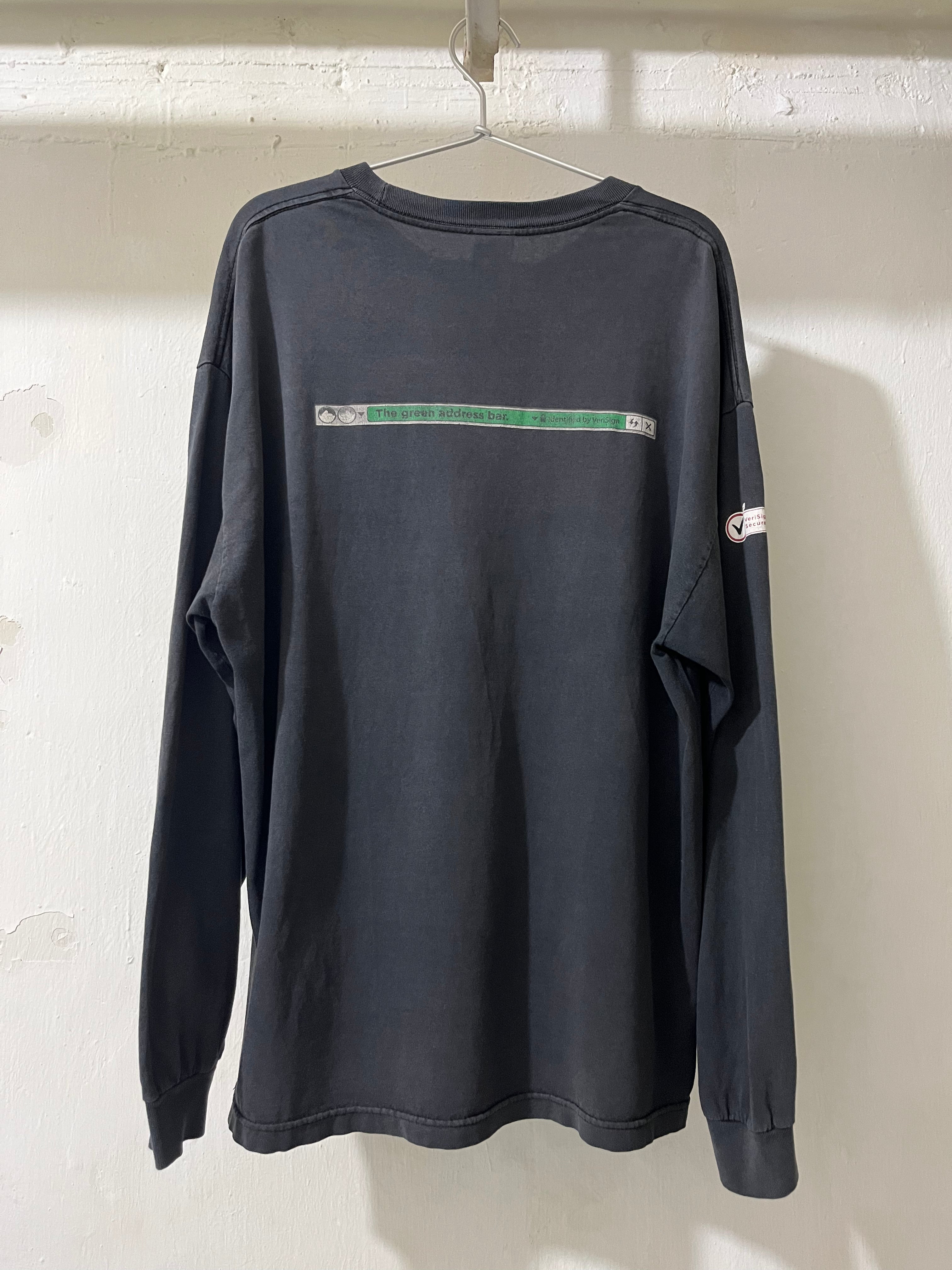Black long-sleeve shirt with a green stripe on a white background