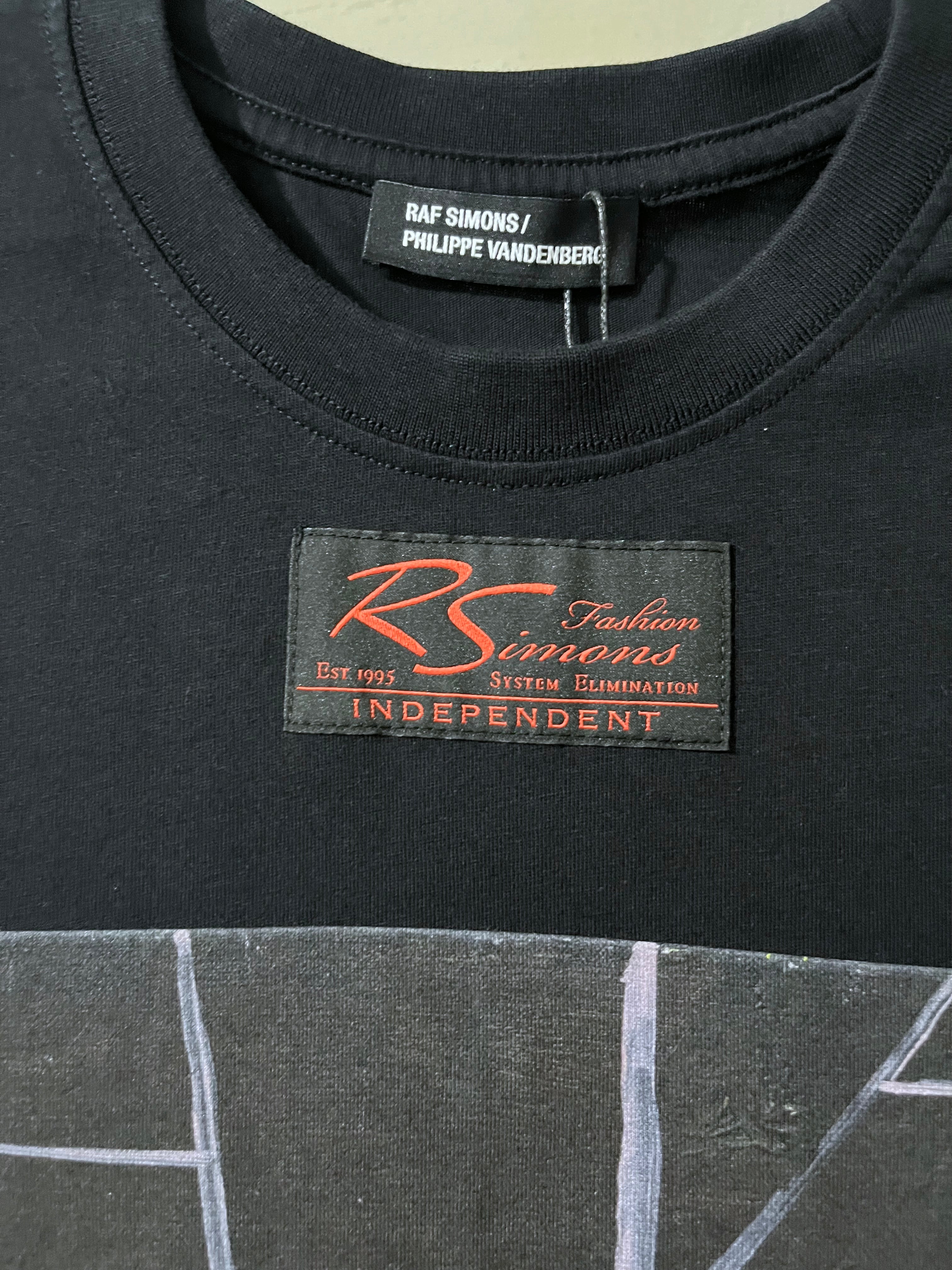 Black t-shirt with a brand label on the collar